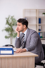 Young male employee working in the office