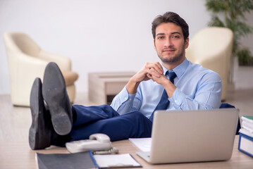 Young male employee working in the office