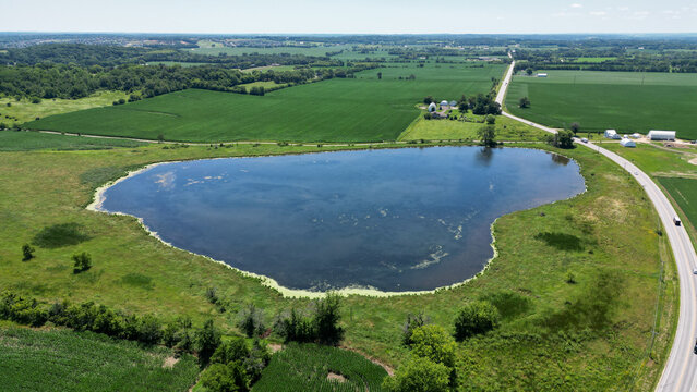 Aerial view over a pond in the summer in the farm land of Madison Wisconsin USA © WeWander