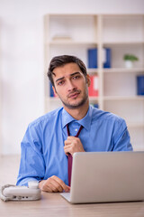 Fototapeta premium Young male employee and too much work in the office