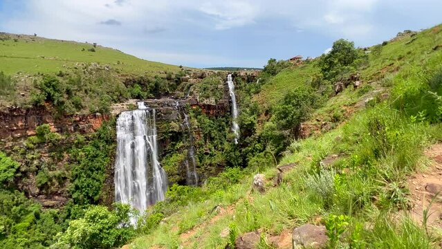 Lisbon Falls Sabie Waterfall South Africa incredible lush green grass in wind spring summer daytime scenic landscape peaceful view adventure Johannesburg gem slow motion pan left