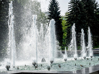 foam jets of water over the city fountain in the park