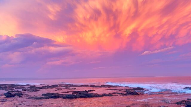 JBay Jefferey's Bay South Africa most stunning best ever incredible summer sunset thunderstorm clouds golden orange red pink waves crash on coastline shore God creation surf paradise pan left