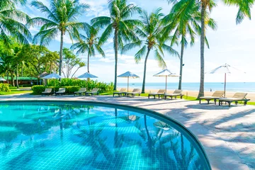 Beautiful umbrella and chair around swimming pool in hotel and resort © topntp