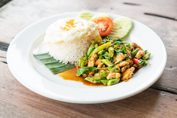 rice and stir fried chicken with basil and fried egg on top