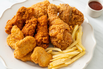 fried chicken with french fries and nuggets on plate