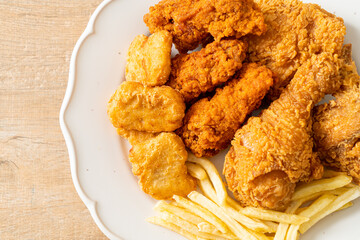 fried chicken with french fries and nuggets on plate