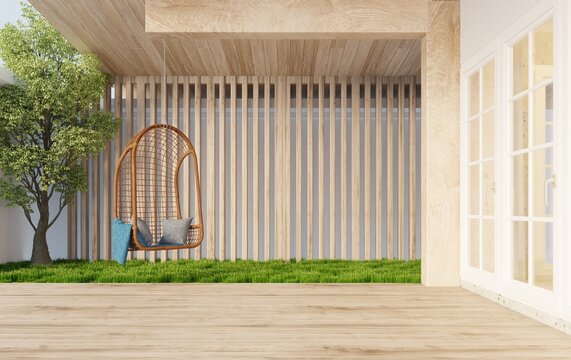 Sitting corner on the front porch, wooden floor with rattan chairs hanging on the wooden beams to sit and relax There is a lawn on the side next to a minimalist wooden slatted wall.3d rendering