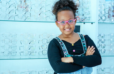 Portrait of young cute and proud girl wearing new pair pf eyeglasses.