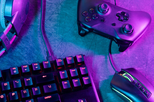 Top view of a gamer's workspace on a desk with an abstract carpet texture and lines.