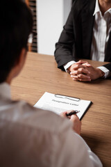 Image of employer or recruiter holding reading a resume during about colloquy his profile of candidate.
