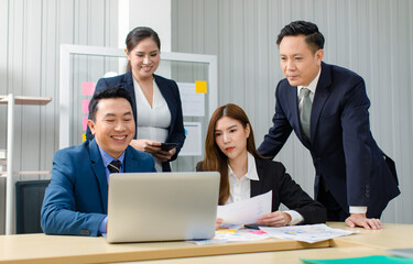 Asian professional successful male female businessmen businesswomen in formal business suit sitting standing smiling in video call meeting online in laptop notebook computer