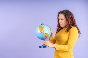 Young woman holding a terrestrial globe