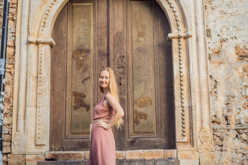 Fototapeta premium Woman tourist in Old town Kaleici in Antalya. Turkiye. Panoramic view of Antalya Old Town port, Taurus mountains and Mediterrranean Sea, Turkey