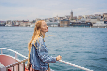 Happy woman enjoying the sea from ferry boat crossing Bosphorus in Istanbul. Summer trip to Istanbul