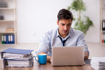 Young male employee working in the office