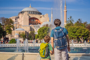 Father and son Tourists enjoy beautiful view on Hagia Sophia Cathedral, famous islamic Landmark...