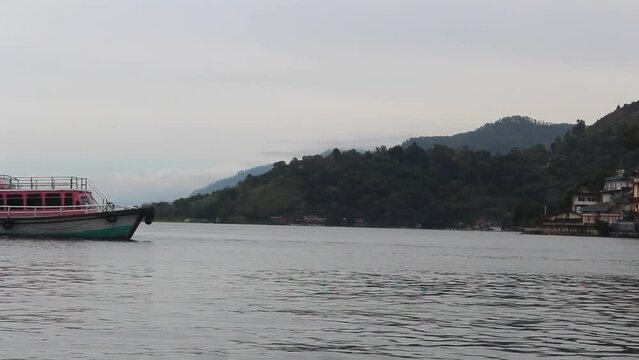 Ferries sailing in the waters of Lake Toba, North Sumatra, Indonesia. Lake Toba tourist transportation boats to cross to Samosir Island