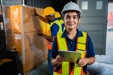 A female worker in a warehouse. professional worker Use a digital tablet computer to check inventory in a warehouse. distribution center.