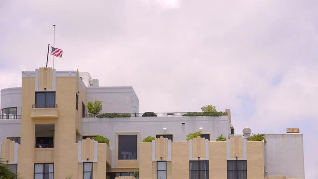 Building wiht an american flag flailing on the roof 4k prores