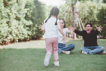 Happy asian family parent and daughter playing together at home outdoor