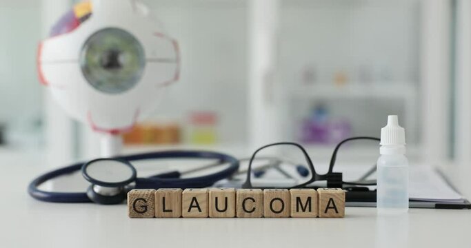 Glaucoma inscription on wooden cubes on the table in the hospital, close-up. Vision pathology, diagnosis