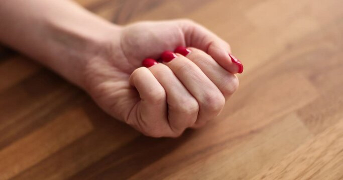 The female hand squeezes a red heart in the palm of the hand. Cardiovascular disease, concept