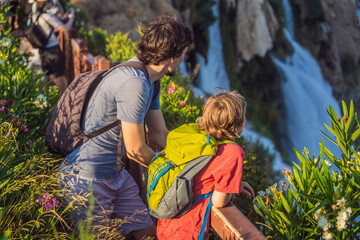 Father and son tourists on the background of Duden waterfall in Antalya. Famous places of Turkey....
