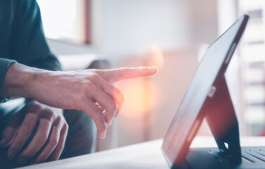 businessman finger pointing at tablet screen in concept of business data analysis