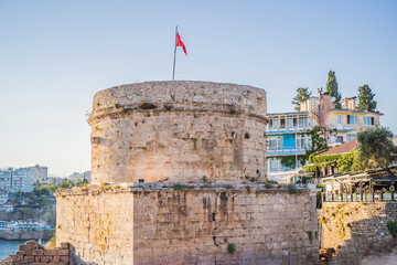 The Hidirlik Tower in Antalya against the backdrop of the Mediterranean bay of the ancient Kaleici...