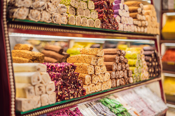 Traditional oriental sweet pastry cookies, nuts, dried fruits, pastilles, marmalade, Turkish desert with sugar, honey and pistachio, in display at a street food market