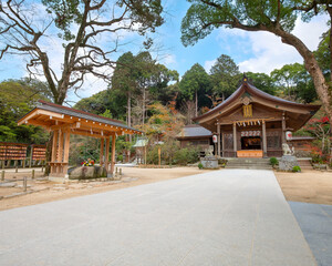 Fototapeta premium Fukuoka, Japan - Nov 30 2022: Homangu Kamado shrine located at Mt. Homan, venerated from ancient times as a sacred mountain, the shrine probably the inspiration for Kimetsu no Yaiba: Demon Slayer