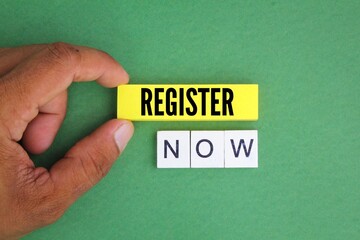 alphabet letters and colored paper with the word register now. instant register concept