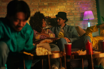 Couple hanging out with friends at home.