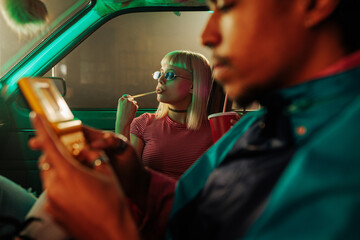 Girl and man socializing in car.