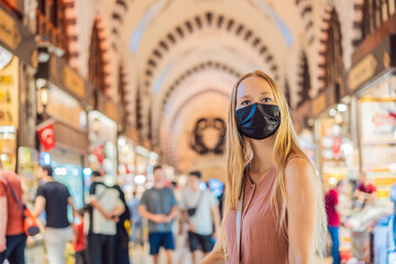 A tourist woman walks among the countless shops at the Grand Bazaar and Egyptian Bazaar in Istanbul. Shopping and travel in Turkey concept. Istanbul historical Egyptian Bazaar. Misir Carsisi, spice