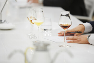 Blind tasting, close up. Sommelier makes notes on the tasting card.