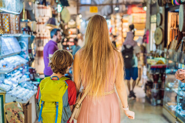mother and son tourists walks among the countless shops at the Grand Bazaar and Egyptian Bazaar in...