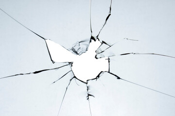 Old broken glass. A hole in the window on a white background crack. Texture for design