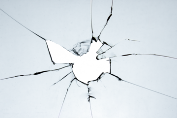 Old broken glass. A hole in the window on a white background crack. Texture for design