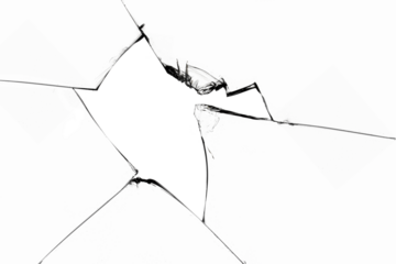 A broken window with cracks and pieces of sharp glass. Cracked texture for design