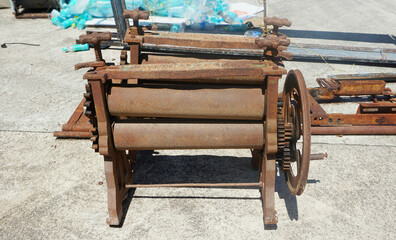 Rusty old iron Rubber Sheet Roller Machine, Old mechanical metal gears mechanism.