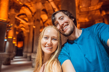 Happy couple enjoying Beautiful cistern in Istanbul. Cistern - underground water reservoir build in...