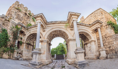 Obraz premium Hadrian Kapisi turkey landmark city history. Popular tourist attraction - ancient Roman Hadrian Gate in old town Antalya, Turkey on a summer day. Turkiye