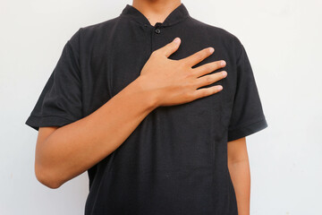 The man in the black shirt placed one hand on his chest in greeting