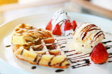 Waffle get served in the morning in the restaurant or the cafe. Food and drink set made by chef and served with hot drink. Healthy food or junk food was select by people with warm light.