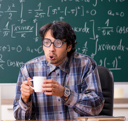 Funny male math teacher in the classroom
