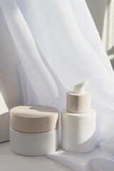 Skincare Bottles in Morning Light with White Fabric