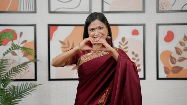 Indian woman making heart sign