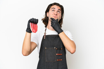 Butcher handsome man wearing an apron and serving fresh cut meat isolated on white background...